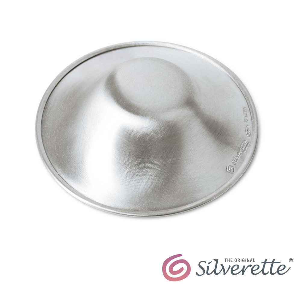 Silverette® Nursing Cups in silver, designed for breastfeeding comfort, shown in a close-up image highlighting their smooth, rounded shape.