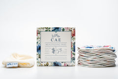 Open box of CAE washable bamboo nursing pads, included in the Silverette Welcome Baby Gift Set
